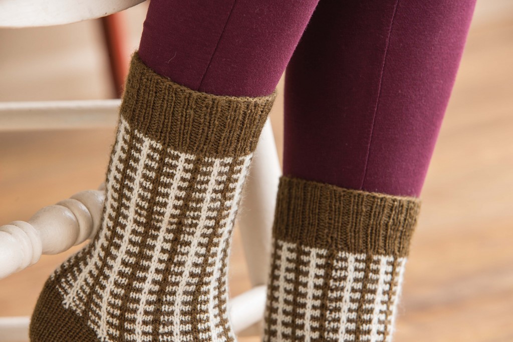 Learn how to knit socks with a simple slip-stitch pattern worked into two colors to create a faux-plaid effect!