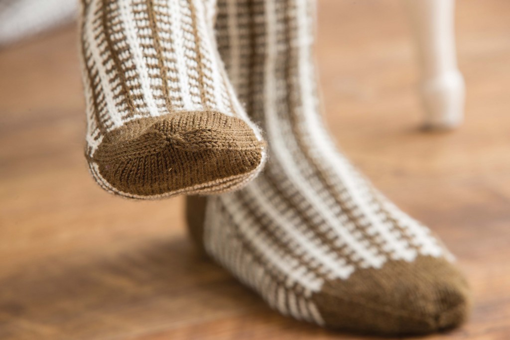 Learn how to knit socks with a simple slip-stitch pattern worked into two colors to create a faux-plaid effect!