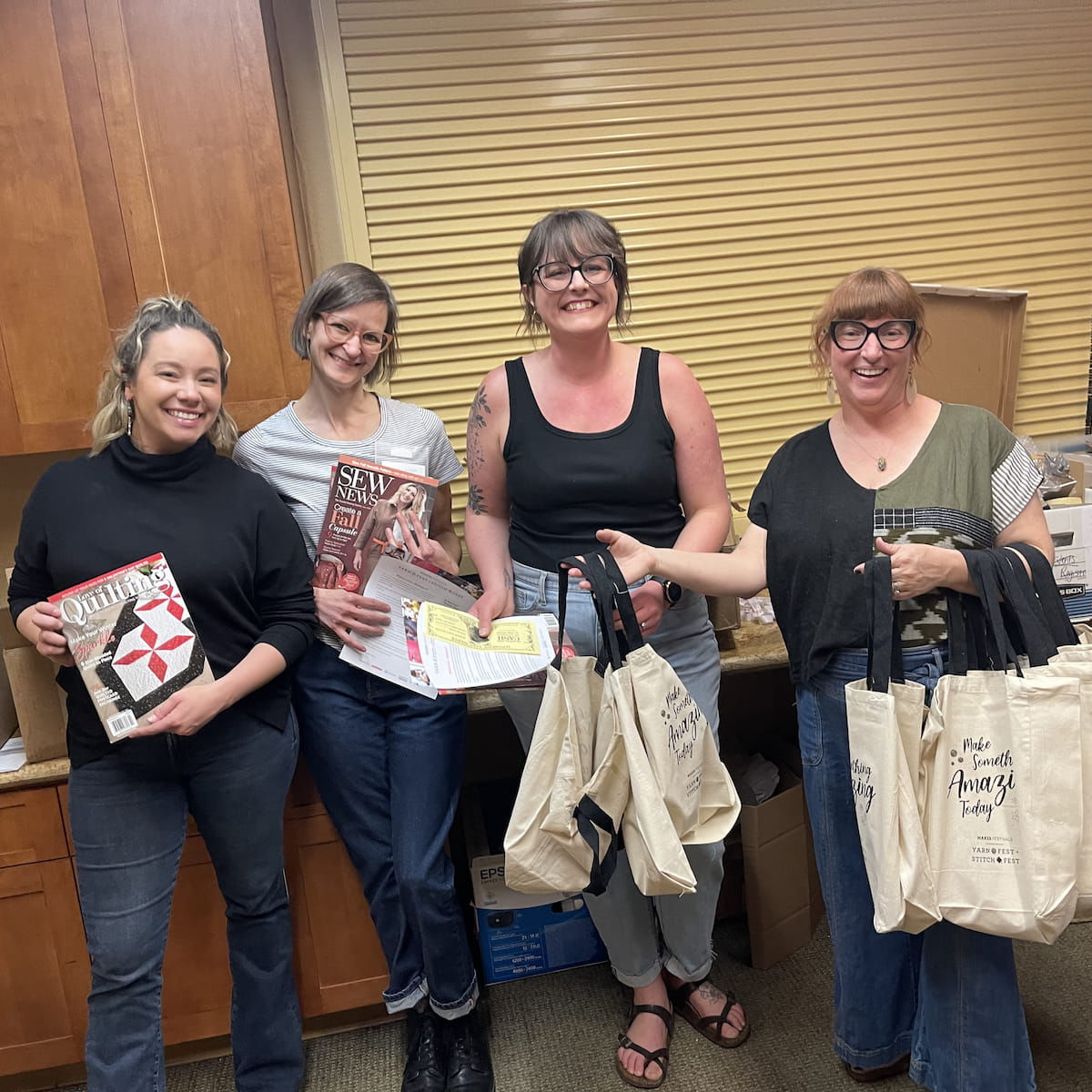 Stuffing goodie bags at the Loveland 2023 Maker Festivals event