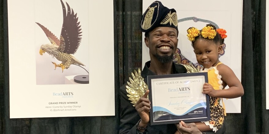 Bead artist Sunday Olaniyi and his award-winning beaded sculpture, Here I Come