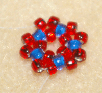 Learn how to do a circular flat peyote stitch in this expert beading blog, step 6 includes stepping up through the first pair of beads added and treating them as a single unit.