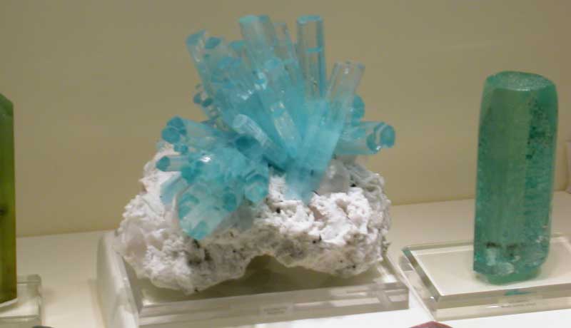 Aquamarine crystal cluster from Pakistan in a case of beryl specimens on display at the 2007 Tucson show; photo: JS White