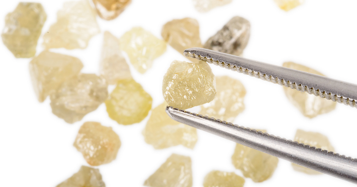 rough diamond crystals and tweezers